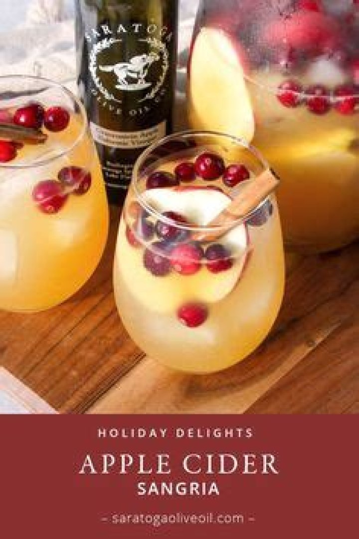 Apple cider sangria with cranberries, orange and apple slices. 