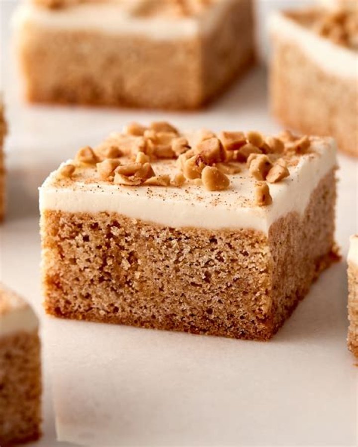Blondie topped with frosting and dried cranberries.