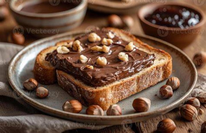 Bread topped with chocolate spread and fresh fruit.