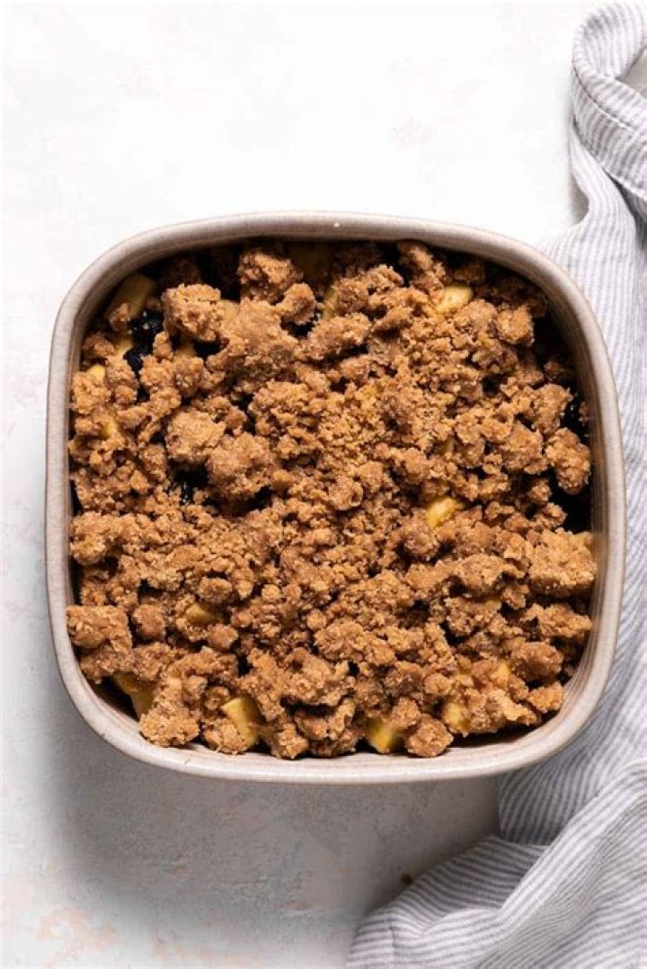 Brown sugar crumble in a glass bowl for a Berry Crisp.