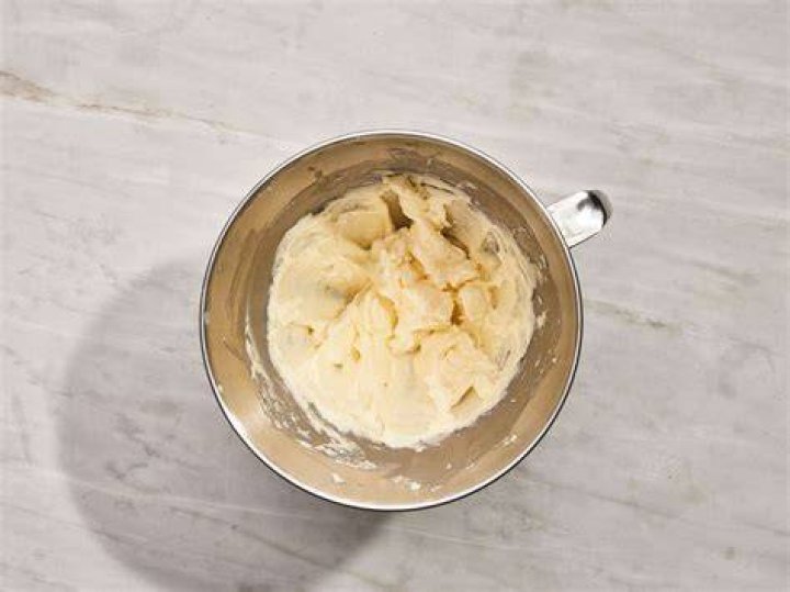 Butter and powdered sugar in a white bowl.