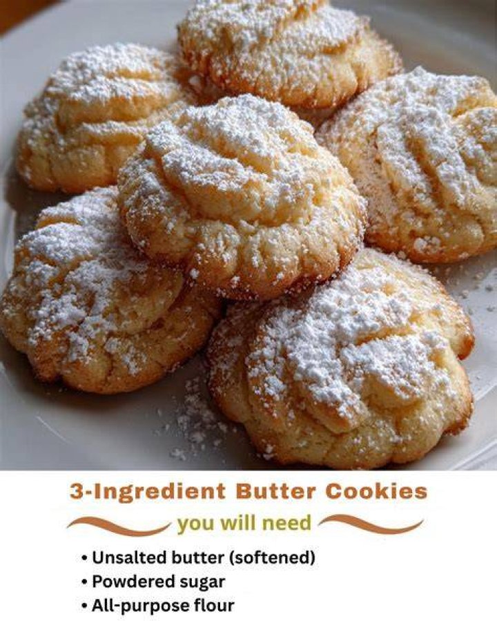 Butter, powdered sugar, jam, and freeze dried strawberries in a white bowl.