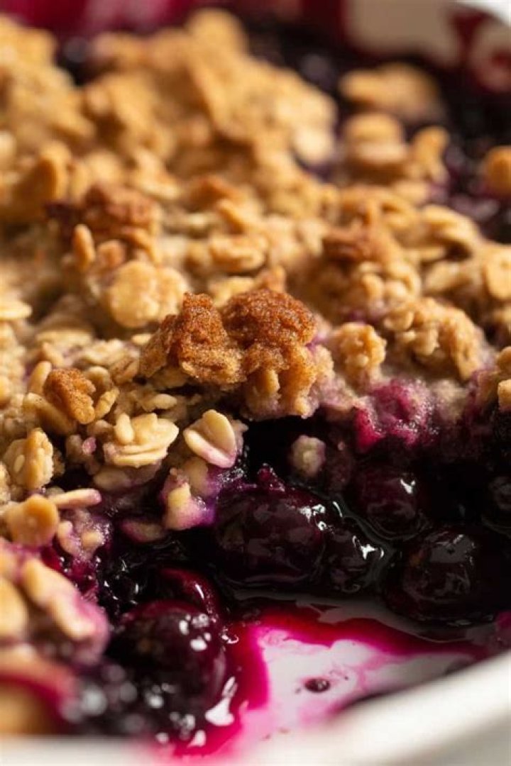 Close up of Blueberry Crisp in a white pie plate.