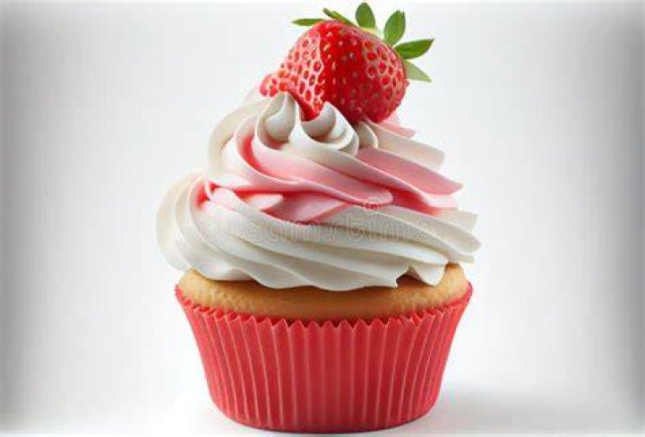 Closeup of strawberry cupcake topped with strawberry frosting