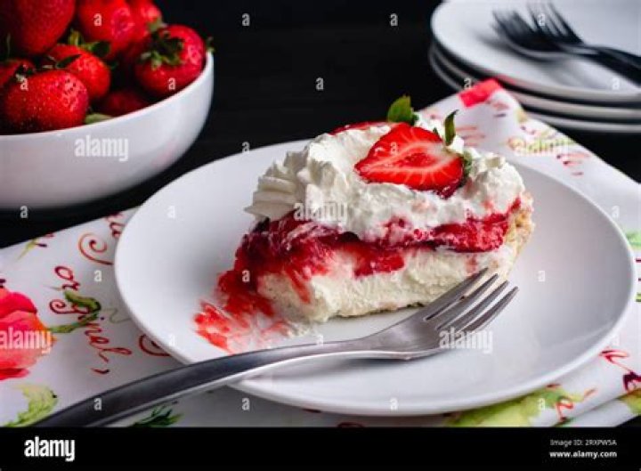 Piece of strawberry pie on a pie plate.