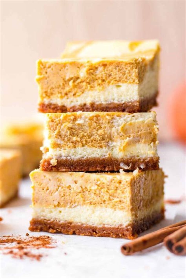 Stack of pumpkin cheesecake bars.