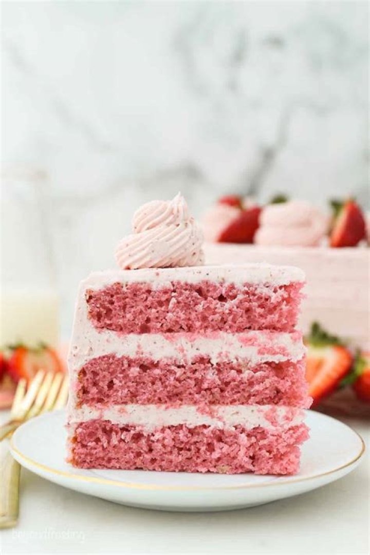 Strawberry frosting in a white bowl