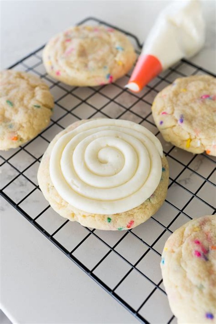 Swirled cream cheese frosting on top of carrot cake.