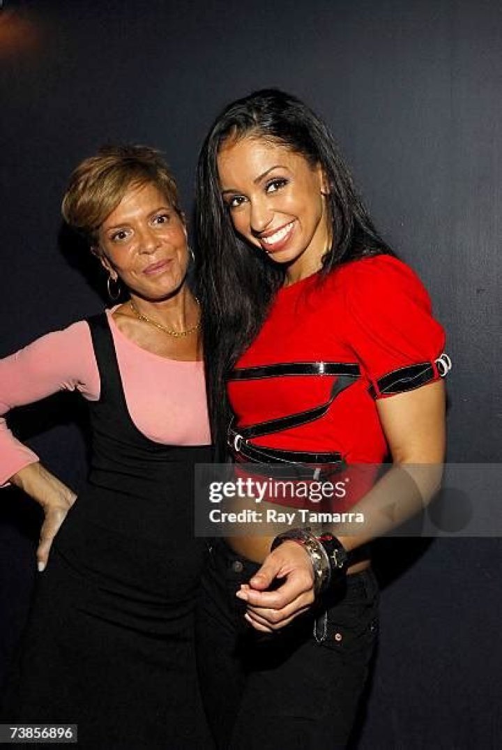 Sylvia Rhone in red shirt poses for a photoshoot.
