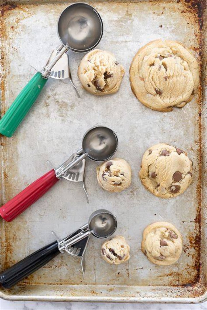 Three scoops of cookie dough ice cream in a white bowl.