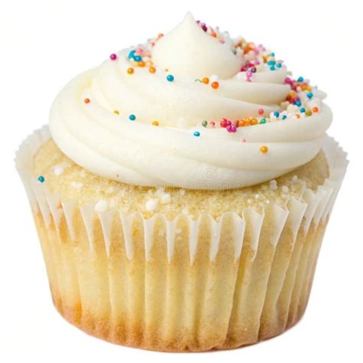 Vanilla cupcake topped with white frosting and sprinkles cut in half.