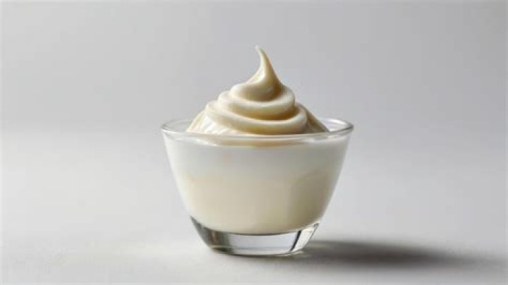 Vanilla pudding in a glass with vanilla wafer cookies.