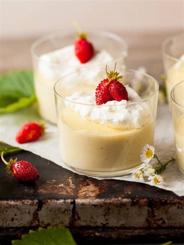 Vanilla pudding topped with whipped cream and crushed cookies.